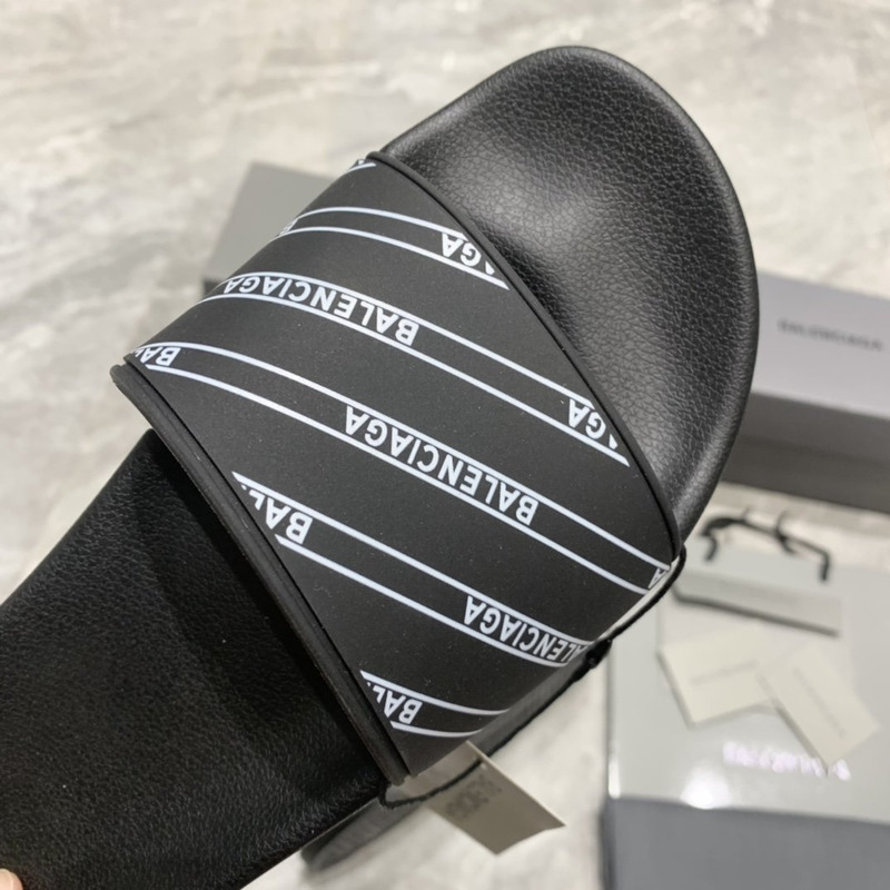 Ba*len*cia*ga black logo pool slides in grain rubber