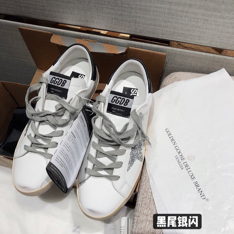 golden goose men’s S*per-star sneakers with silver star and black heel tab