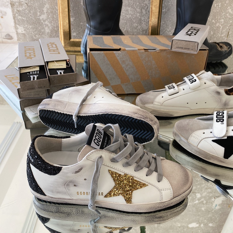 golden goose S*per-star sneakers with golden glitter and black heel tab