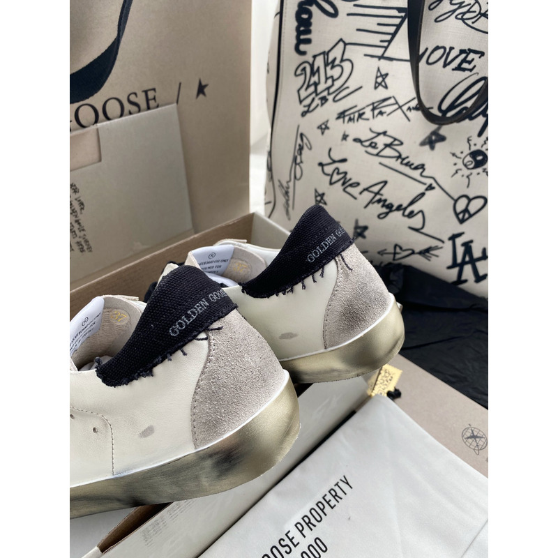 golden goose men’s S*per-star sneakers with black suede star and black heel tab