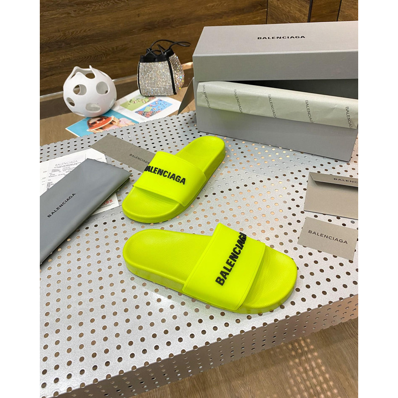 Ba*len*cia*ga pool slide sandal in fluorescent yellow rubber with black 3d Ba*len*cia*ga logo