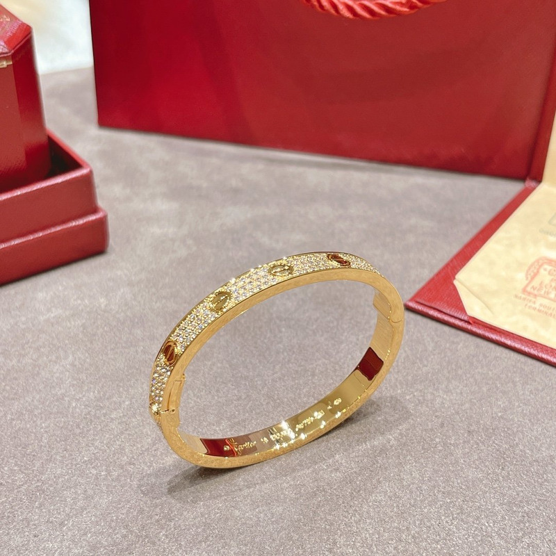 cartier Di*m*nd paved love bangle bracelet in yellow gold