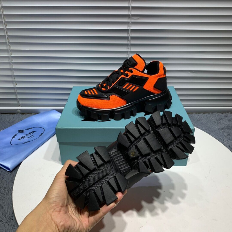 Pra*a cloudbust thunder knit sneakers in black/orange