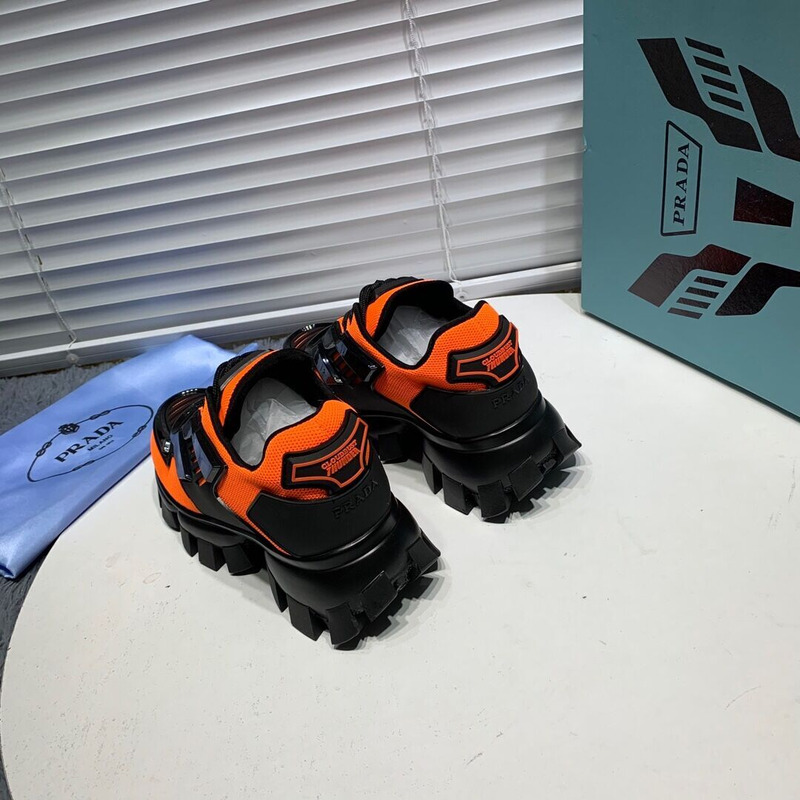 Pra*a cloudbust thunder knit sneakers in black/orange