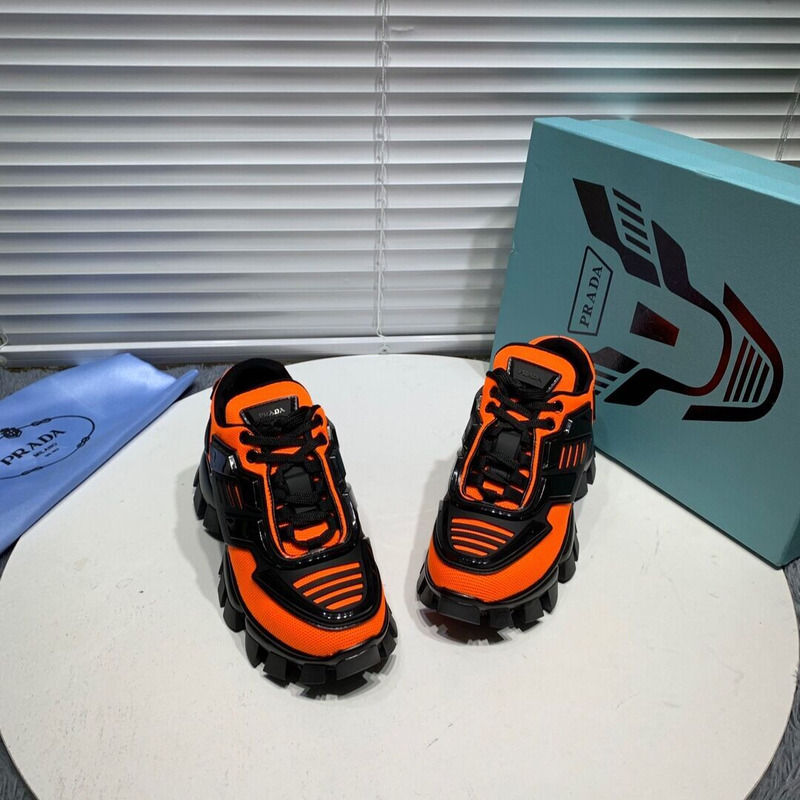 Pra*a cloudbust thunder knit sneakers in black/orange